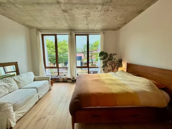 a bedroom with a large bed and a large window