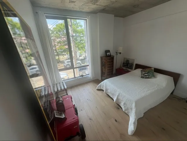a bedroom with a bed and a large window