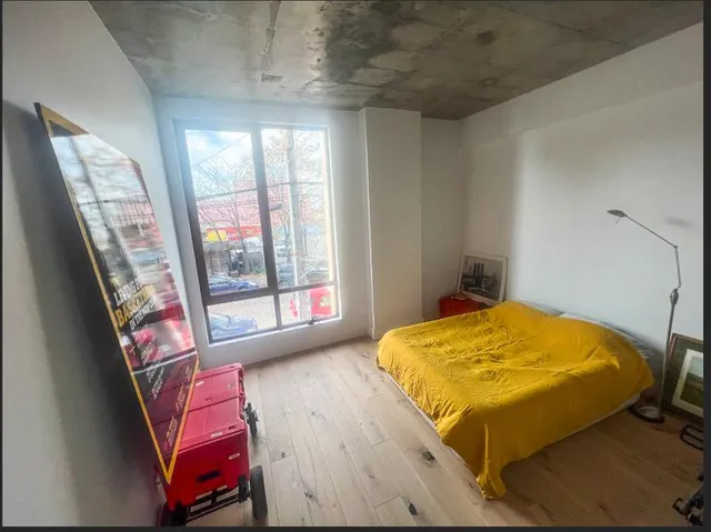 a bed sitting in a bedroom next to a window