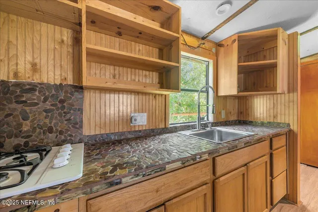 a kitchen with a sink and a window