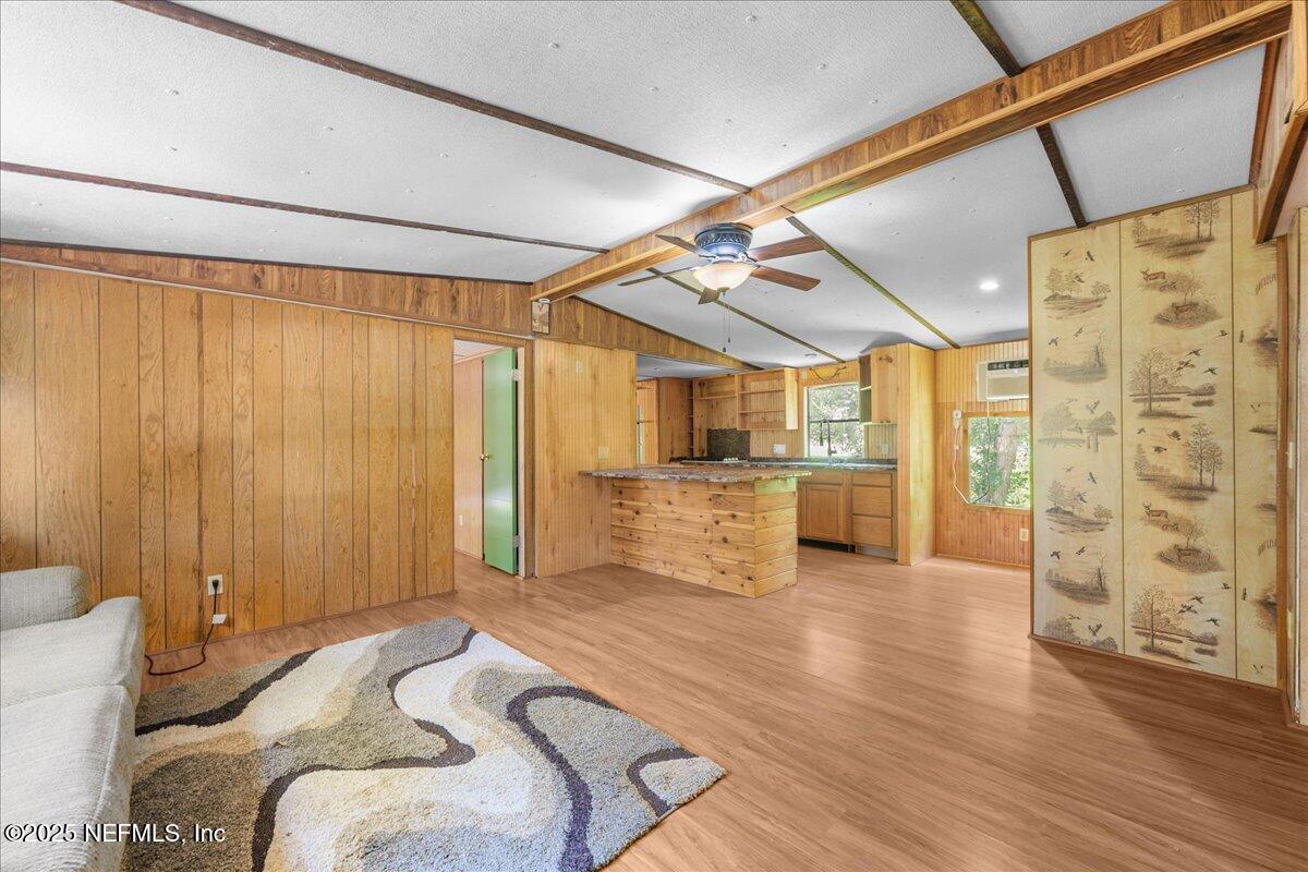 506 Cedar Creek Road, Unit 1 Palatka, FL 32177 - Photo 14 of 49 a bedroom with furniture and a wooden floor
