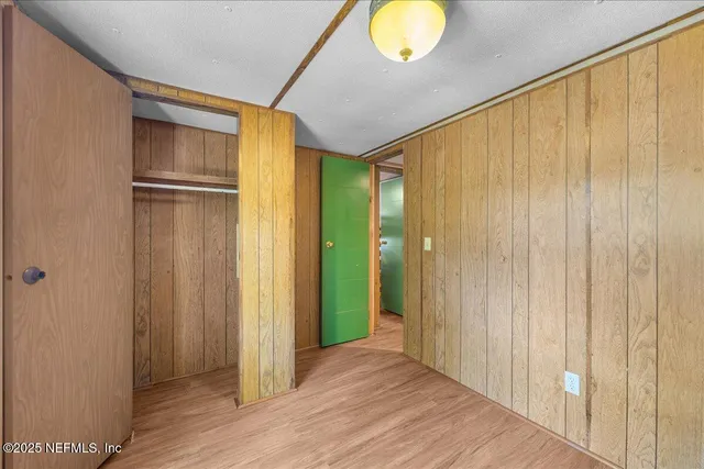 a view of hallway with wooden floor