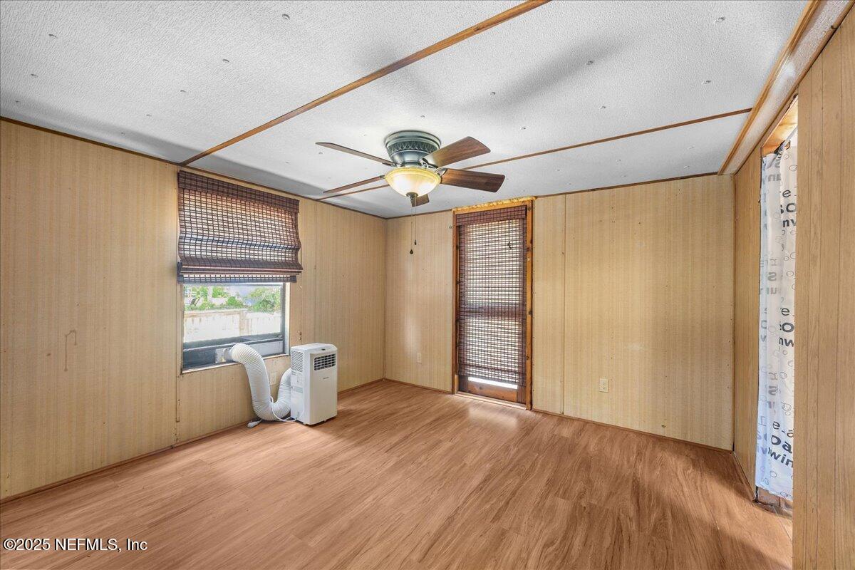 506 Cedar Creek Road, Unit 1 Palatka, FL 32177 - Photo 22 of 49 a very nice looking room with a large window and chandelier fan