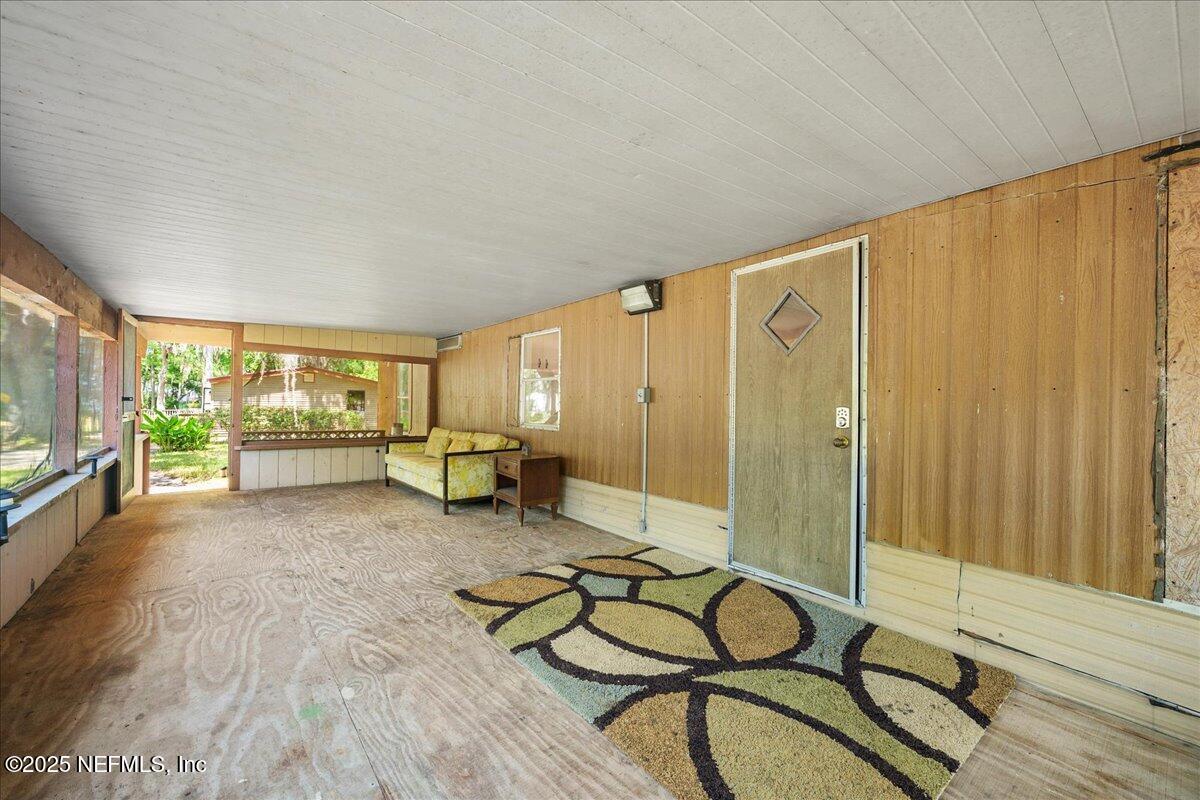 506 Cedar Creek Road, Unit 1 Palatka, FL 32177 - Photo 29 of 49 a living room with furniture and a floor to ceiling window