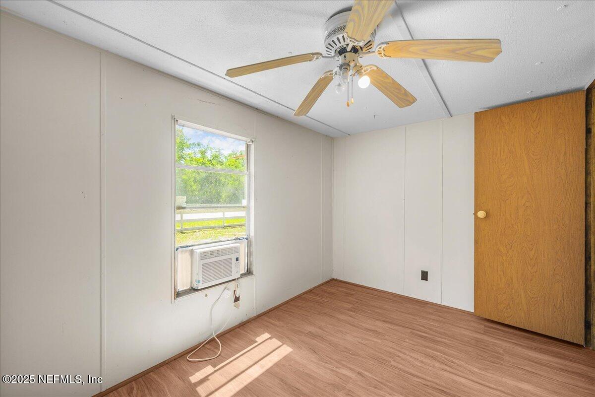 506 Cedar Creek Road, Unit 1 Palatka, FL 32177 - Photo 38 of 49 a view of empty room with wooden floor and fan