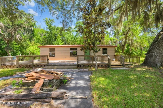 a view of a backyard with a tree