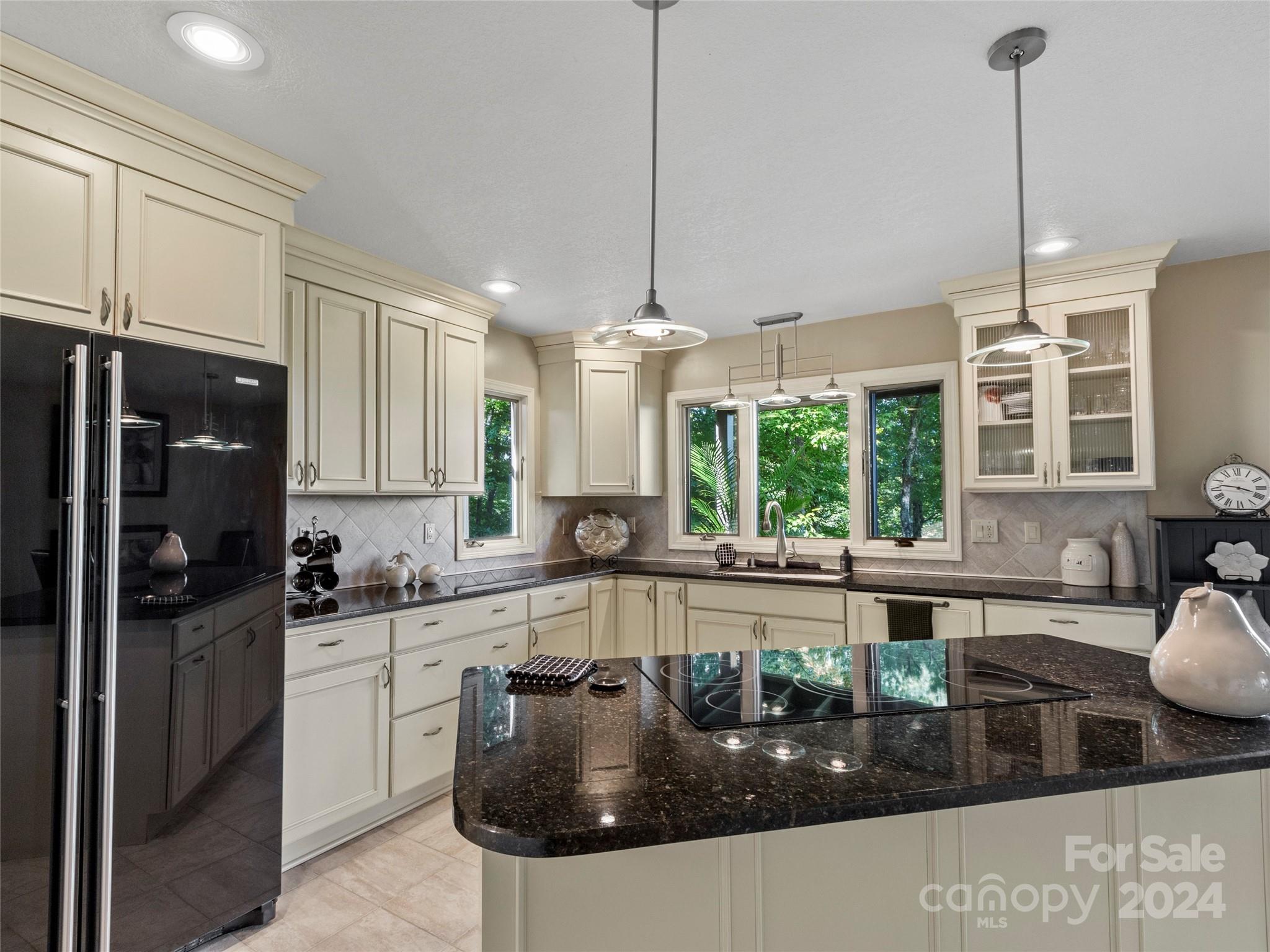 30 Pinkerton Corner Fairview, NC 28730 - Photo 11 of 31 a kitchen with stainless steel appliances granite countertop a sink a stove and refrigerator