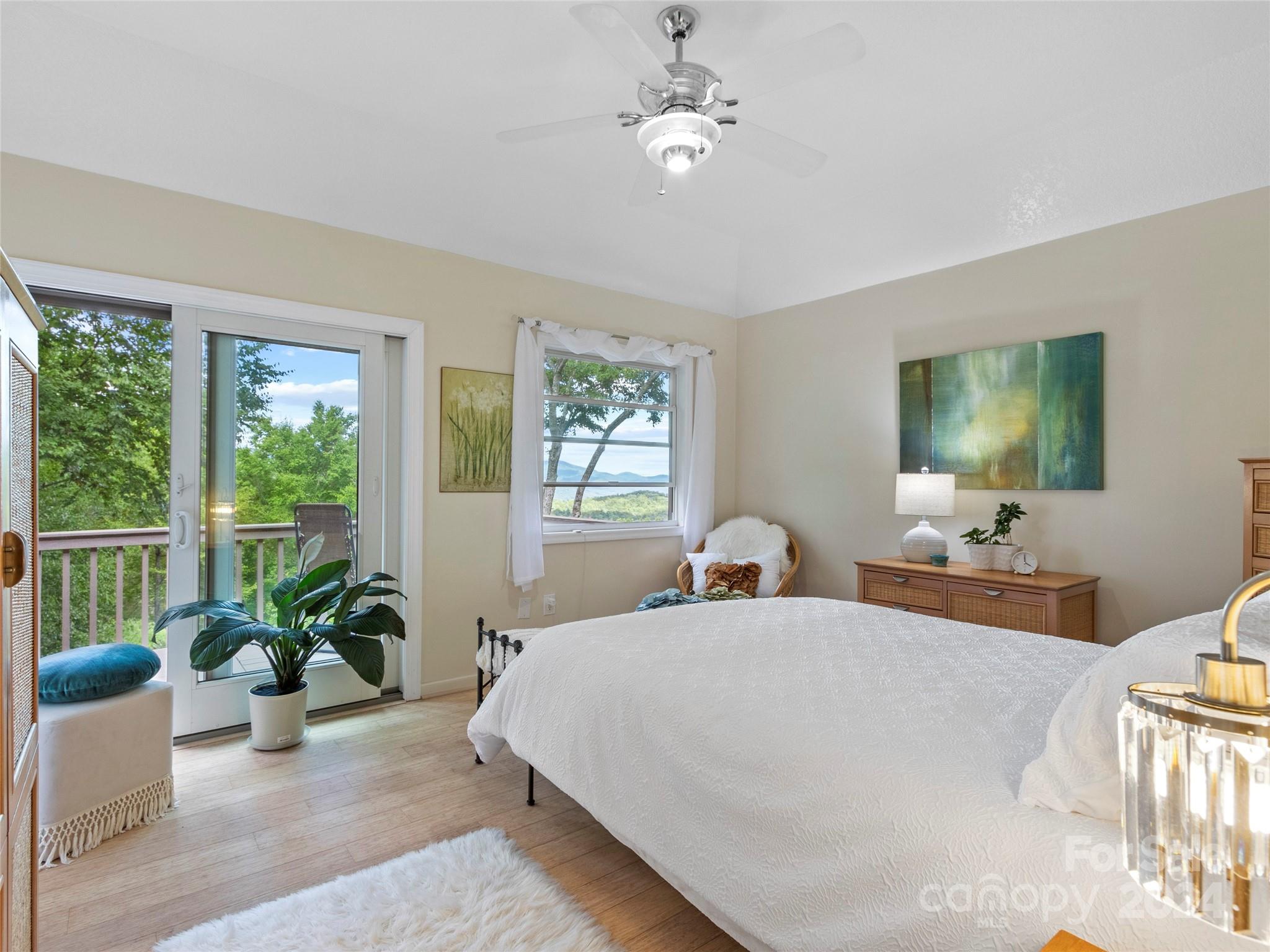 30 Pinkerton Corner Fairview, NC 28730 - Photo 14 of 31 a bedroom with a large bed and a chandelier