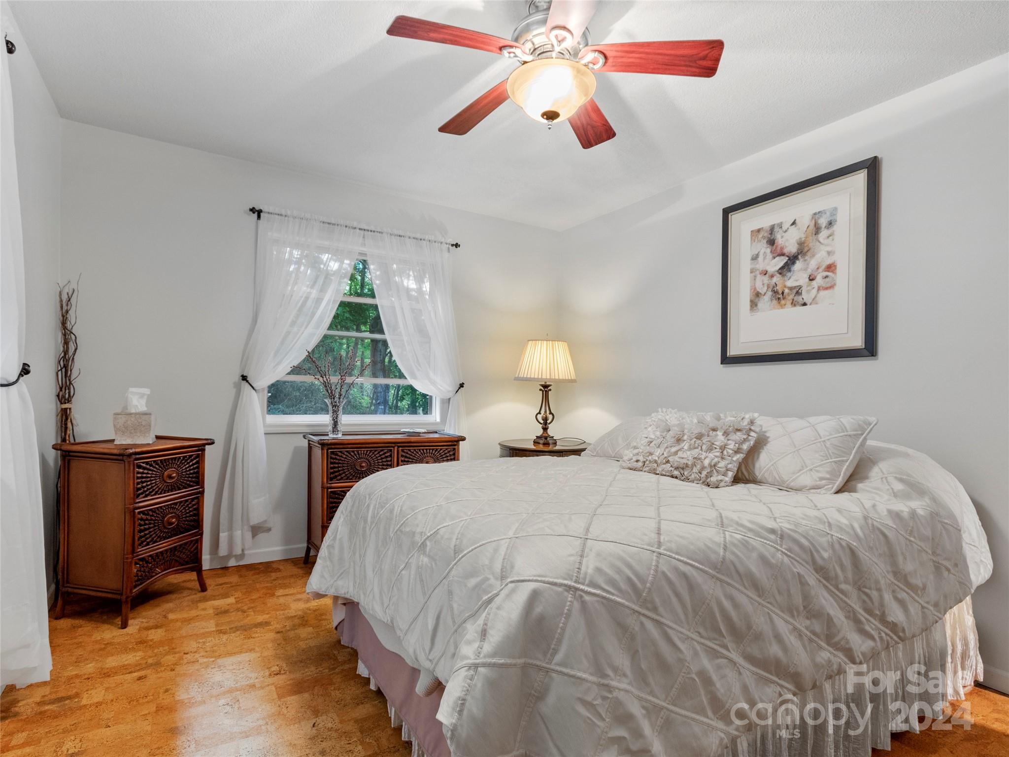 30 Pinkerton Corner Fairview, NC 28730 - Photo 17 of 31 a bedroom with a bed and a chandelier