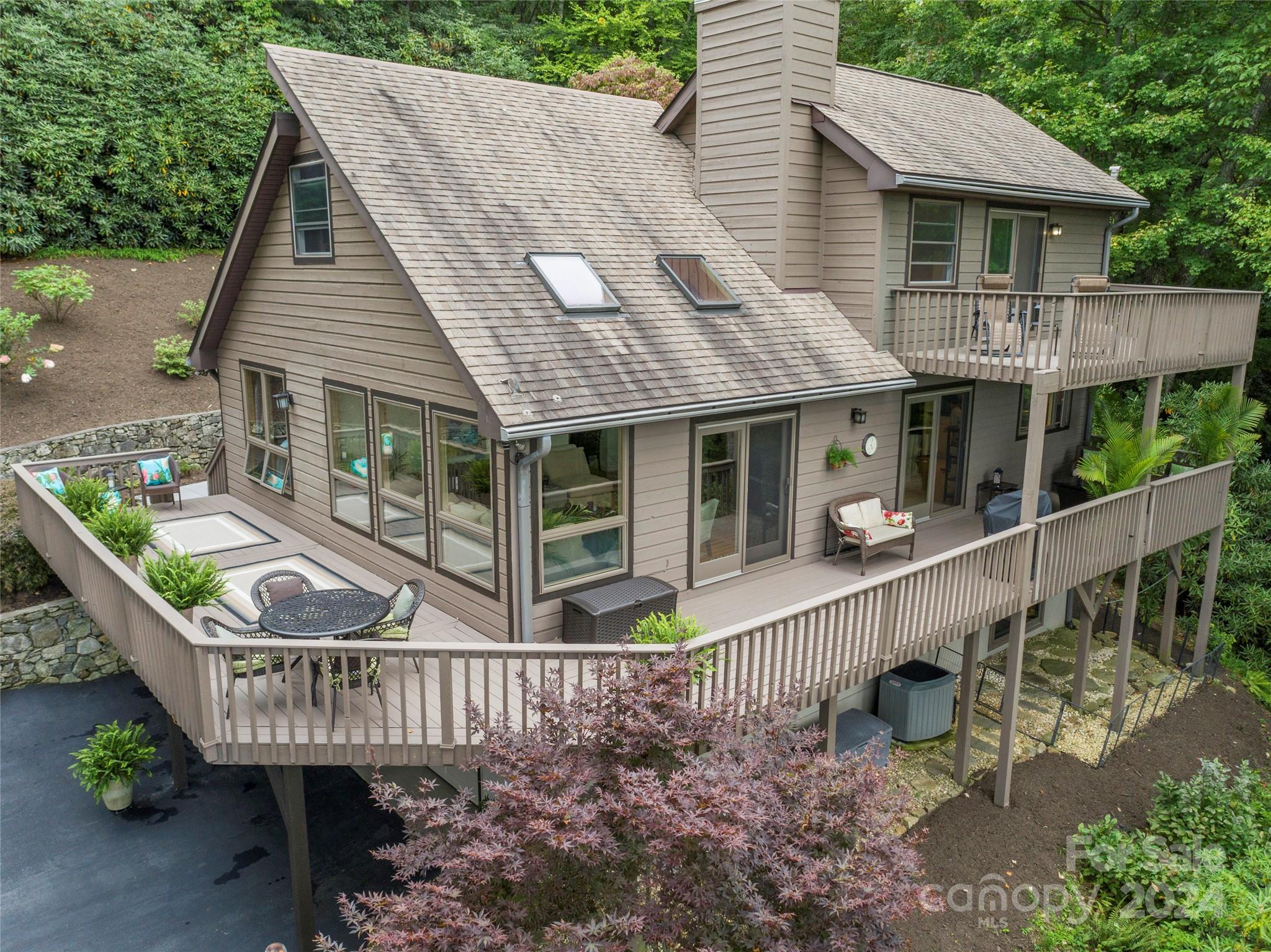 30 Pinkerton Corner Fairview, NC 28730 - Photo 23 of 31 a view of a house with a wooden deck and furniture