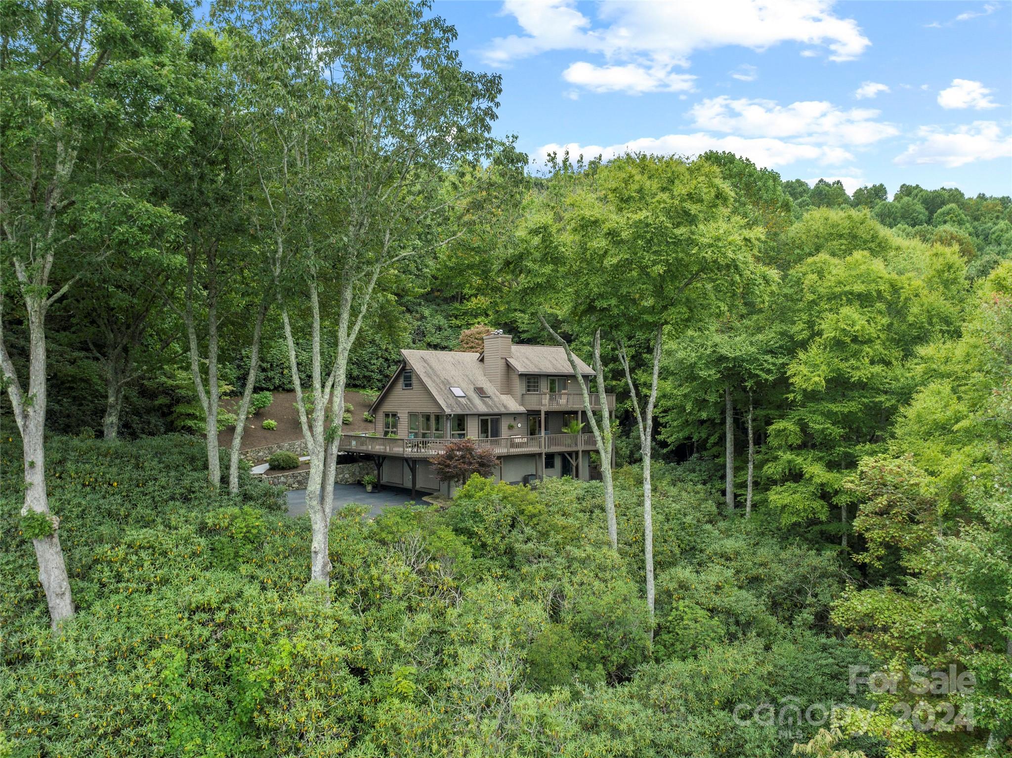 30 Pinkerton Corner Fairview, NC 28730 - Photo 24 of 31 a backyard of a house with plants and outdoor seating