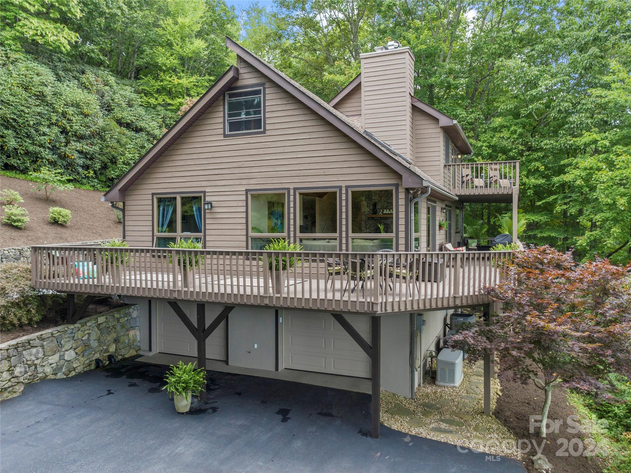 30 Pinkerton Corner Fairview, NC 28730 - Photo 4 of 31 a front view of a house with a garden and deck