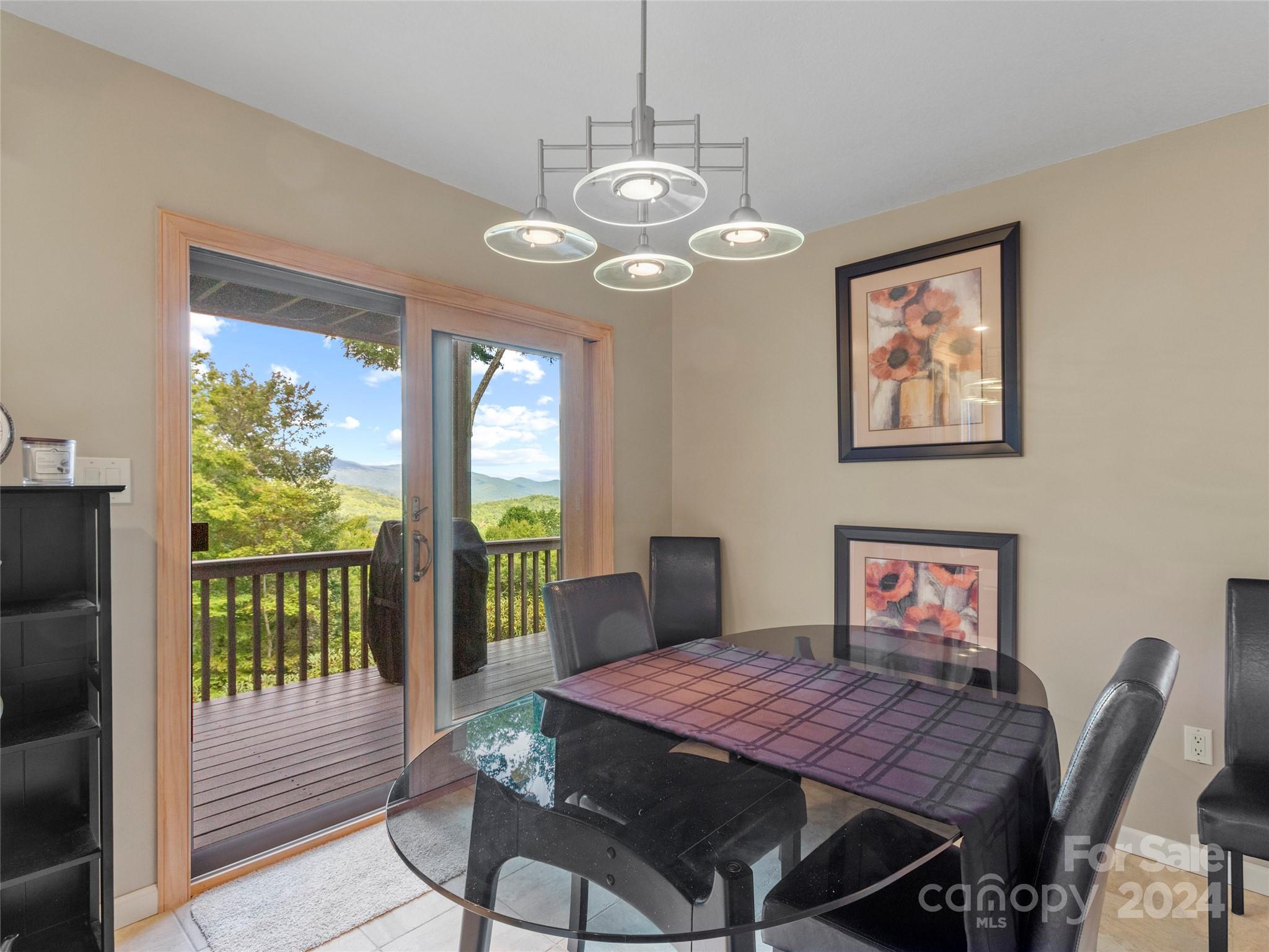 30 Pinkerton Corner Fairview, NC 28730 - Photo 7 of 31 a dining room with furniture a large window and a chandelier