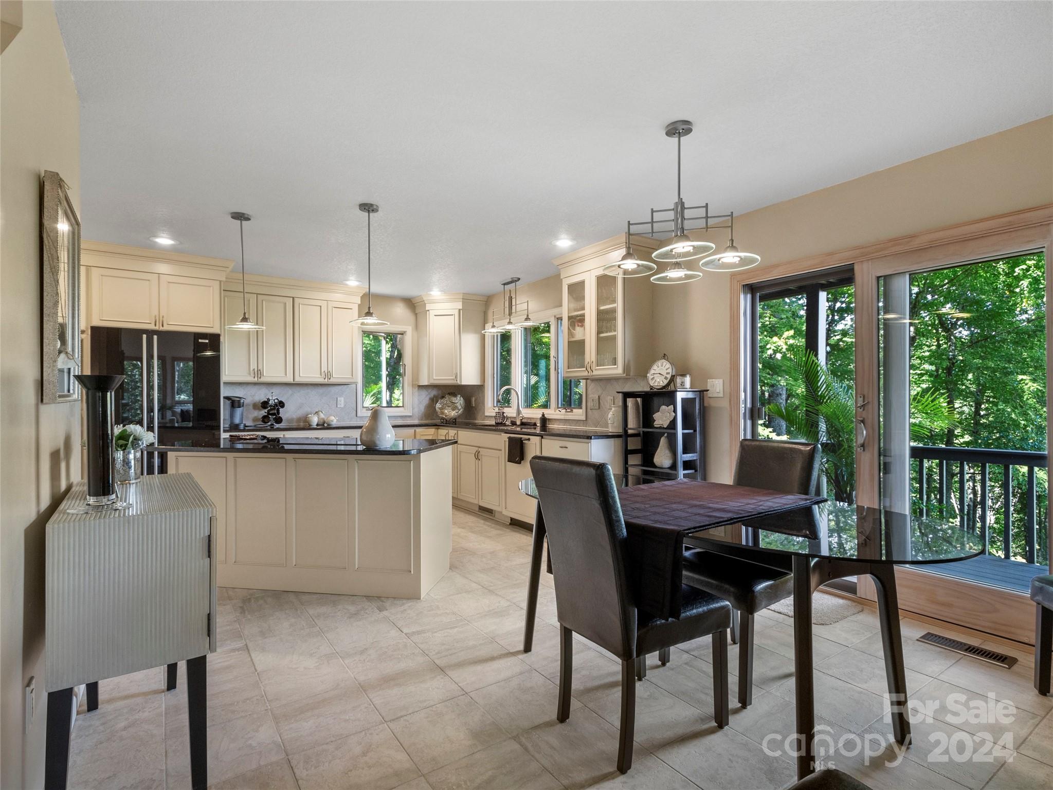 30 Pinkerton Corner Fairview, NC 28730 - Photo 8 of 31 a dining room filled with furniture and a floor to ceiling window