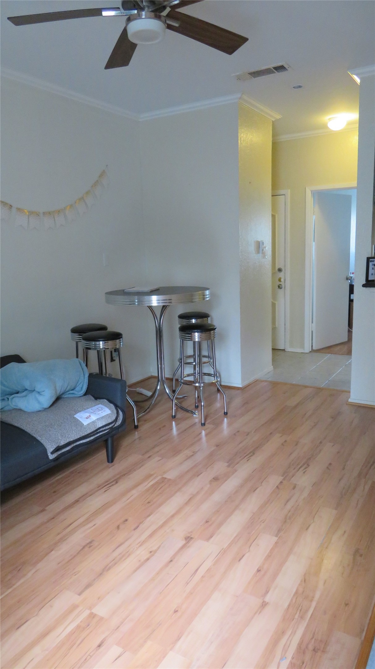 806 West 24th Street, Unit 200 Austin, TX 78705 - Photo 11 of 33 Natural wood flooring complements crown molding in this versatile living area.