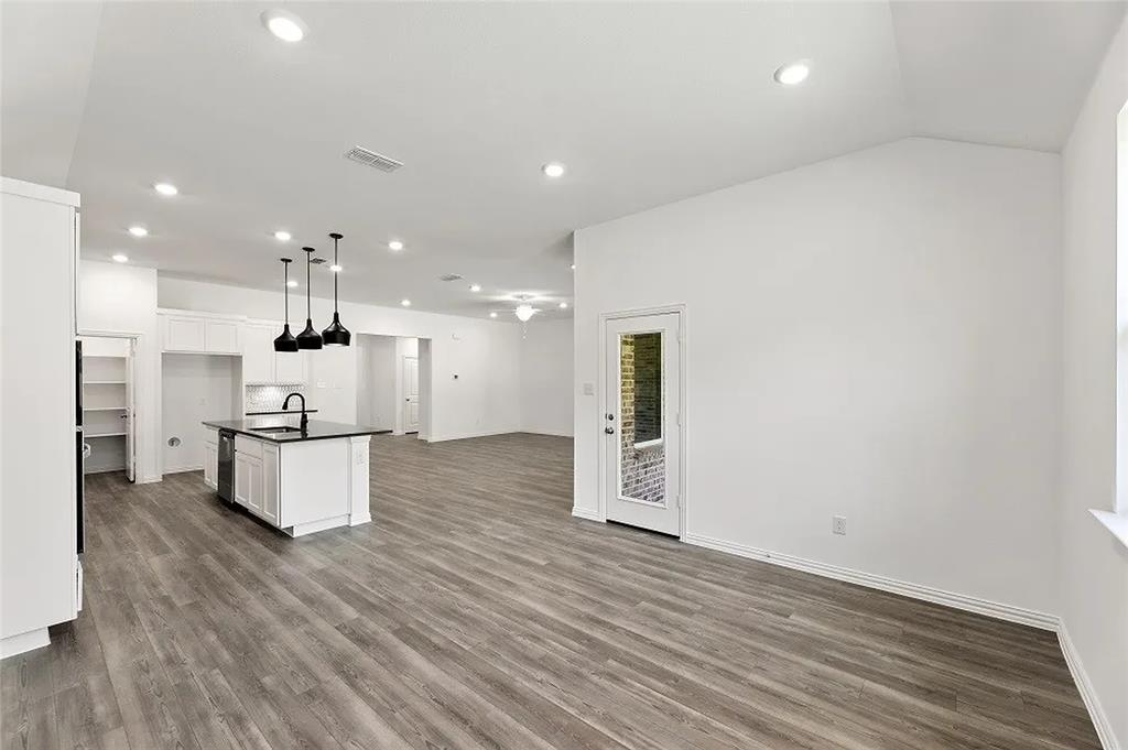 1632 Pavin Lane Fort Worth, TX 76052 - Photo 11 of 37 a kitchen with stainless steel appliances kitchen island granite countertop a stove a sink and a refrigerator