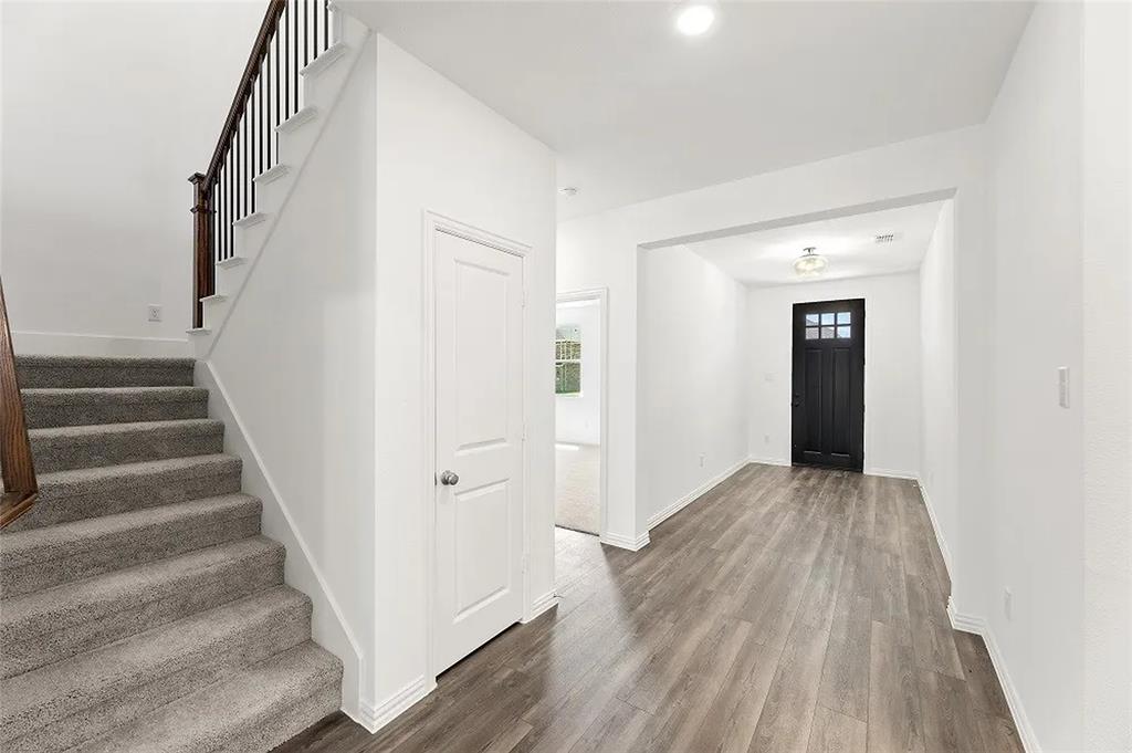 1632 Pavin Lane Fort Worth, TX 76052 - Photo 14 of 37 a view of a hallway with wooden floor and entryway