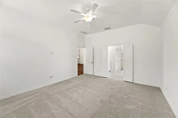 an empty room with fan and a ceiling fan