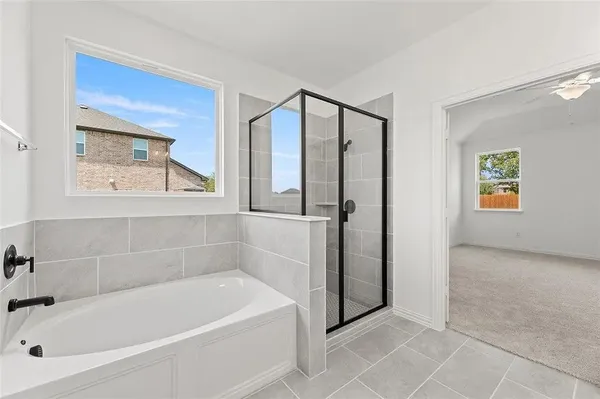 a white bath tub sitting next to a window