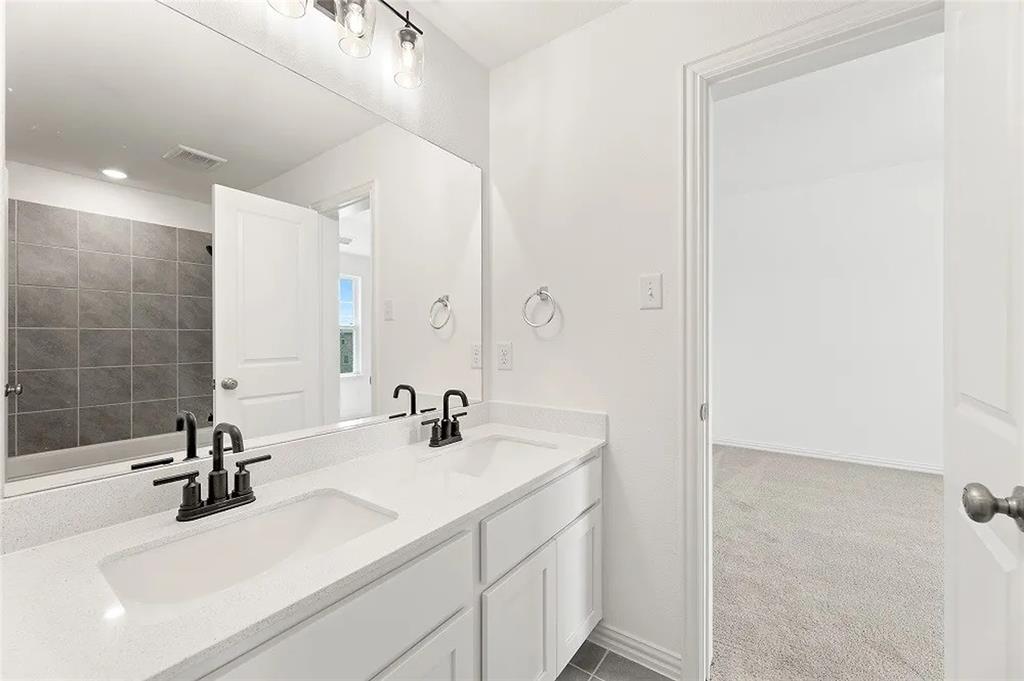1632 Pavin Lane Fort Worth, TX 76052 - Photo 29 of 37 a bathroom with a sink and a mirror