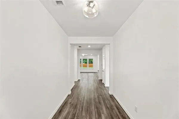 a view of a hallway view with wooden floor and staircase