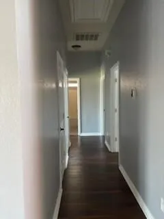 a view of hallway with wooden floor