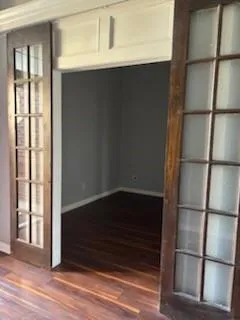 a close view of walk in closet with wooden floor
