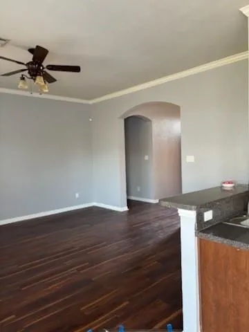 a view of an empty room and wooden floor