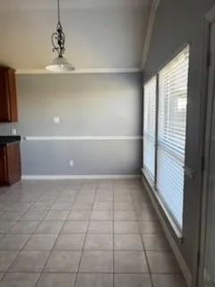 a view of kitchen with window and cabinets
