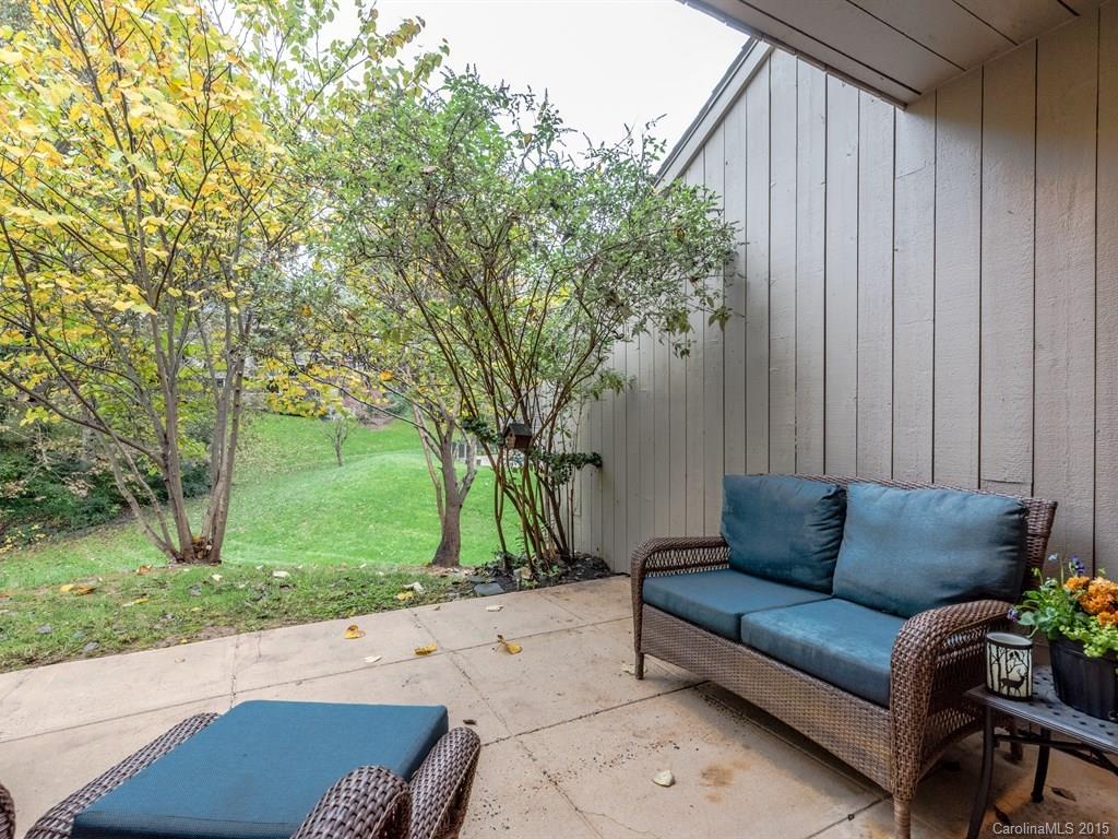42 Old Post Road, Unit 42 Lake Wylie, SC 29710 - Photo 17 of 24 a view of a patio with couches and a table and chairs with wooden fence and large trees