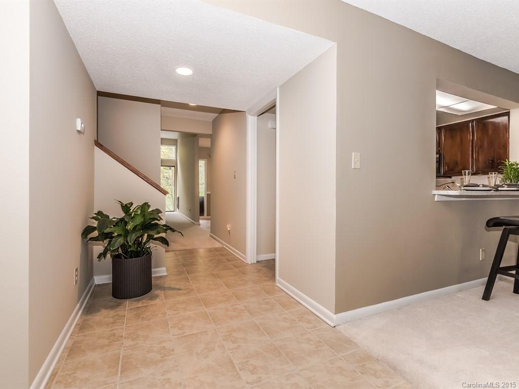 42 Old Post Road, Unit 42 Lake Wylie, SC 29710 - Photo 3 of 24 a hallway with a couch and a potted plant