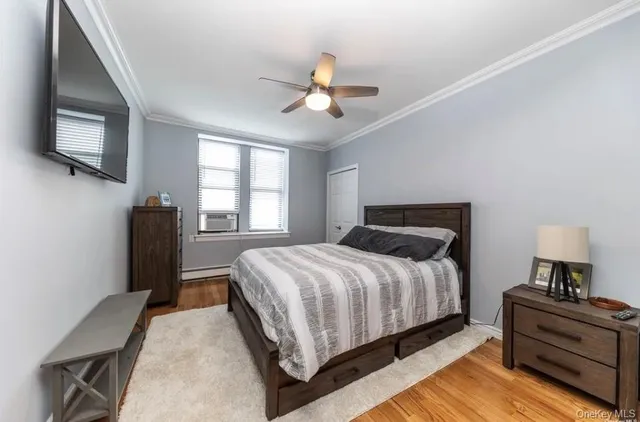 a bedroom with a bed and a television