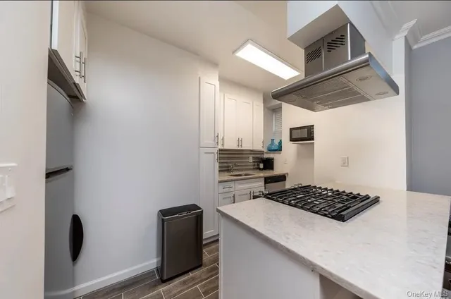 a kitchen with a refrigerator and a stove top oven