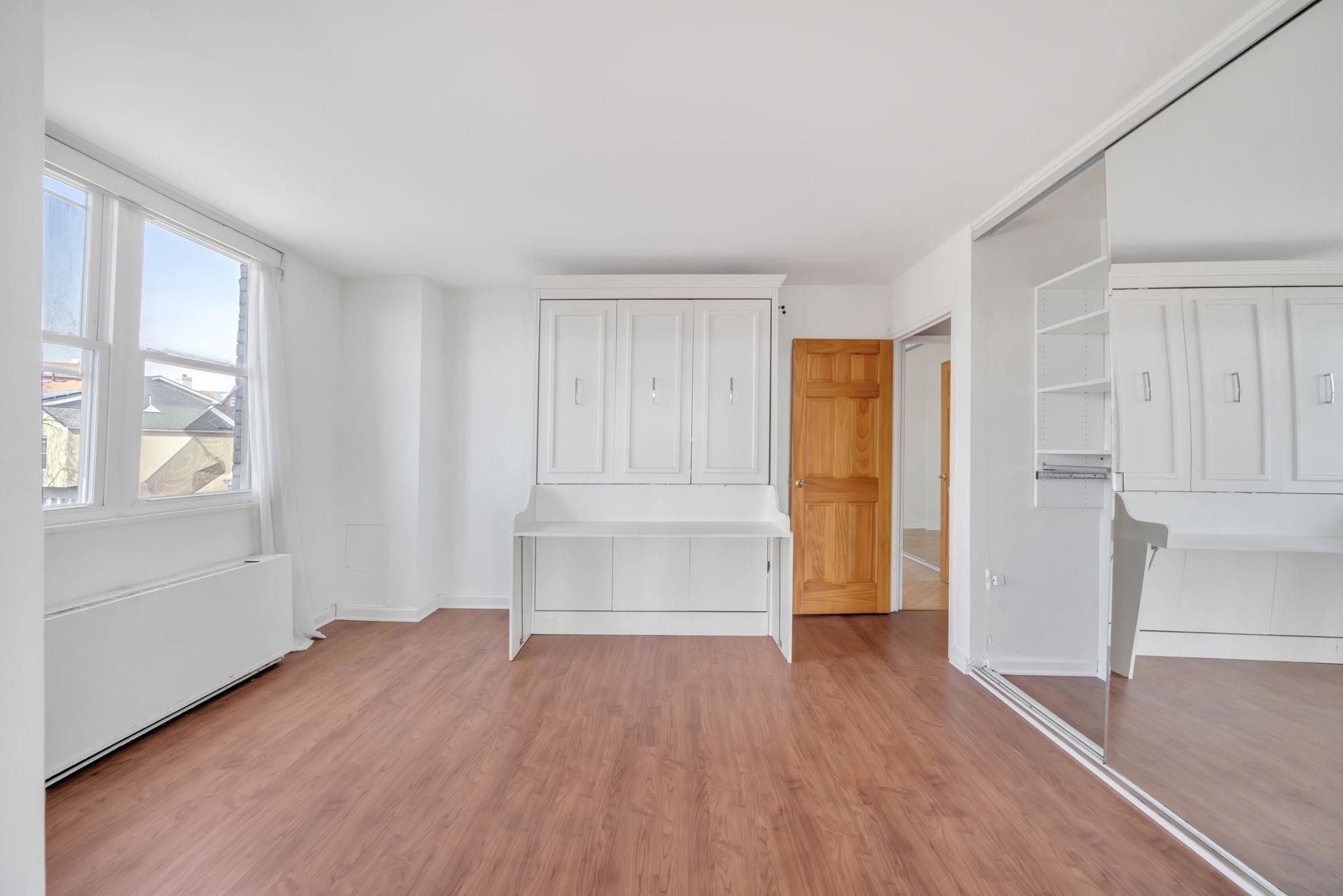 380 Mountain Road, Unit 213 Union City, NJ 07087 - Photo 18 of 36 a view of empty room with wooden floor and entryway