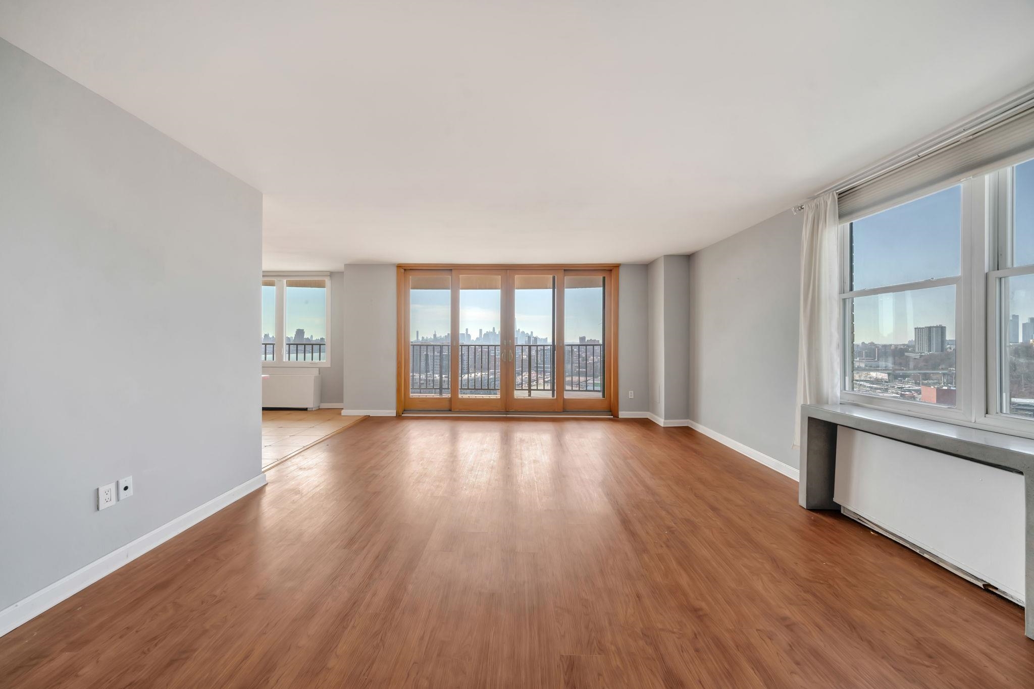 380 Mountain Road, Unit 213 Union City, NJ 07087 - Photo 2 of 36 wooden floor in an empty room with a window