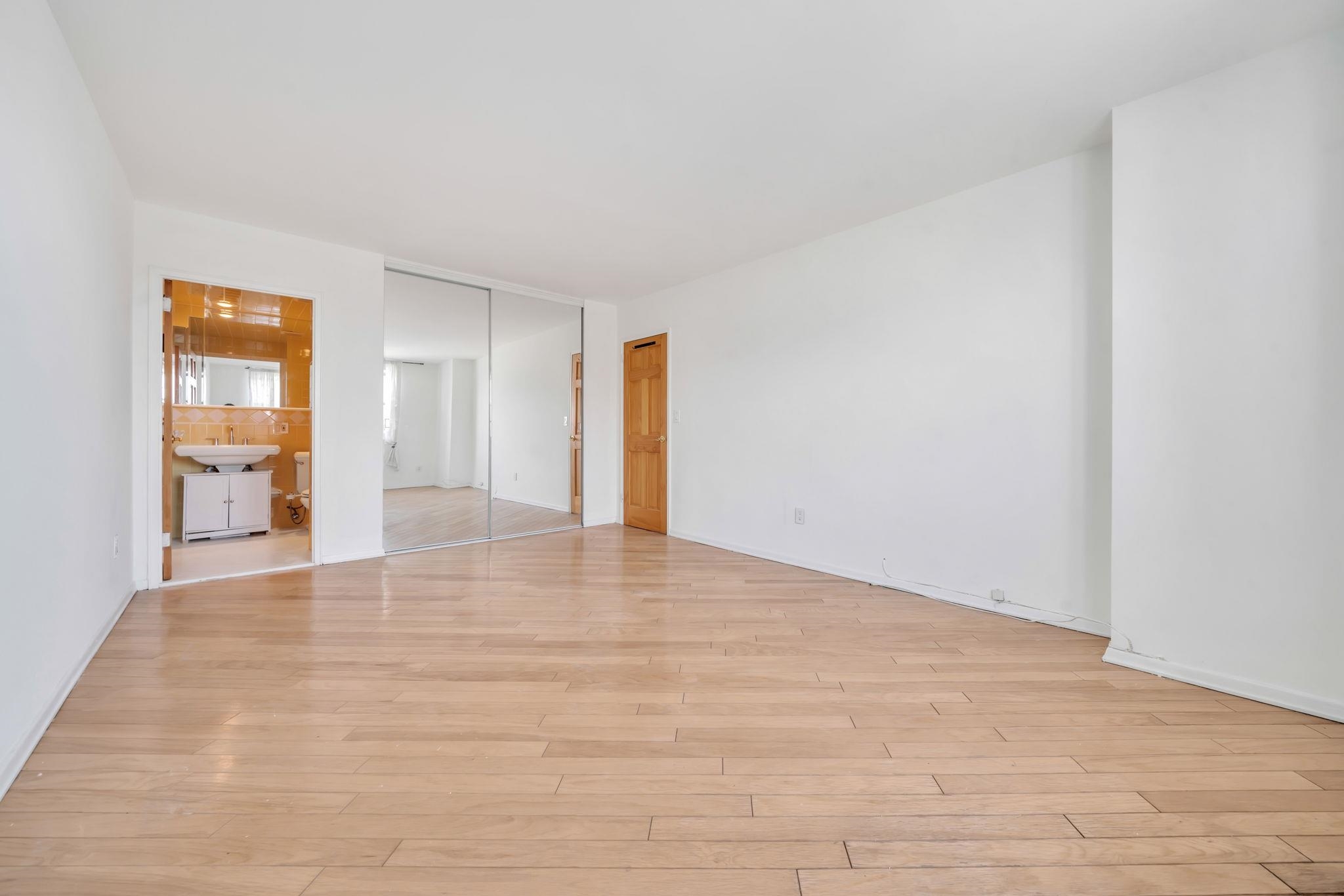 380 Mountain Road, Unit 213 Union City, NJ 07087 - Photo 25 of 36 a view of an empty room with wooden floor and a window