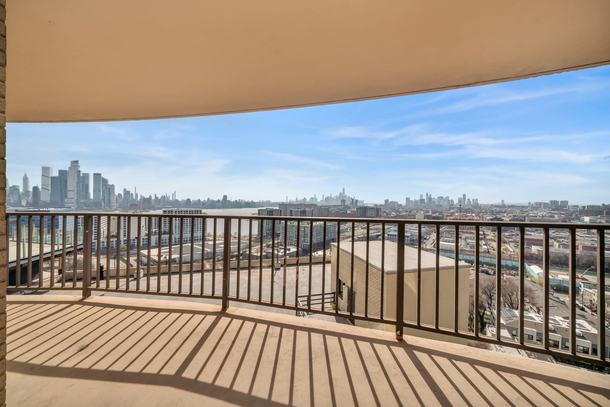 380 Mountain Road, Unit 213 Union City, NJ 07087 - Photo 30 of 36 a balcony with wooden floor and city view