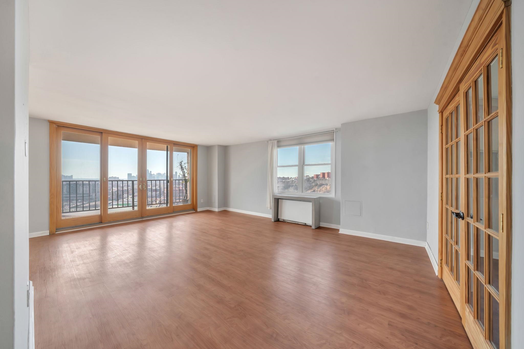 380 Mountain Road, Unit 213 Union City, NJ 07087 - Photo 3 of 36 a view of an empty room with a window and wooden floor
