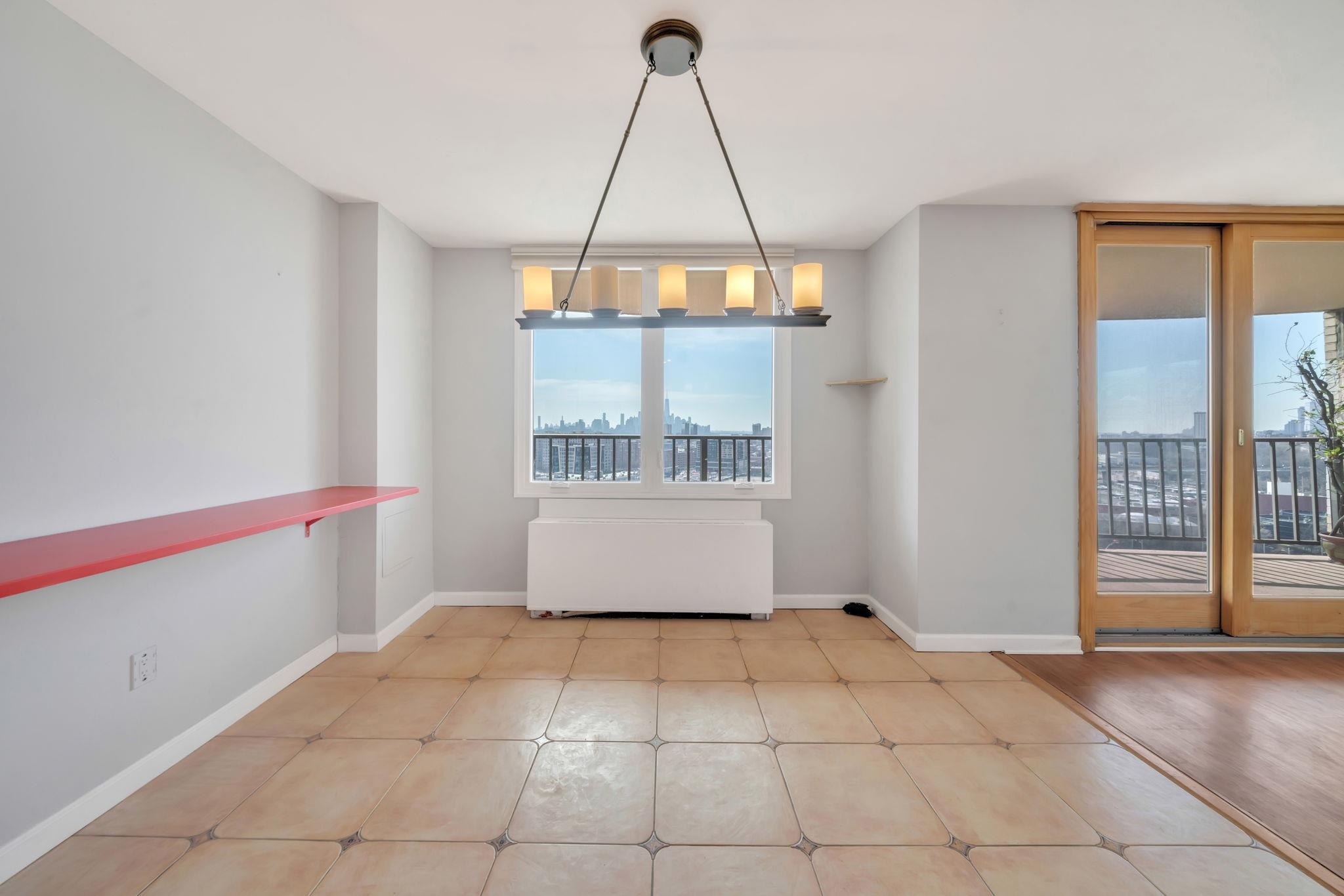 380 Mountain Road, Unit 213 Union City, NJ 07087 - Photo 10 of 36 a view of an empty room with a window