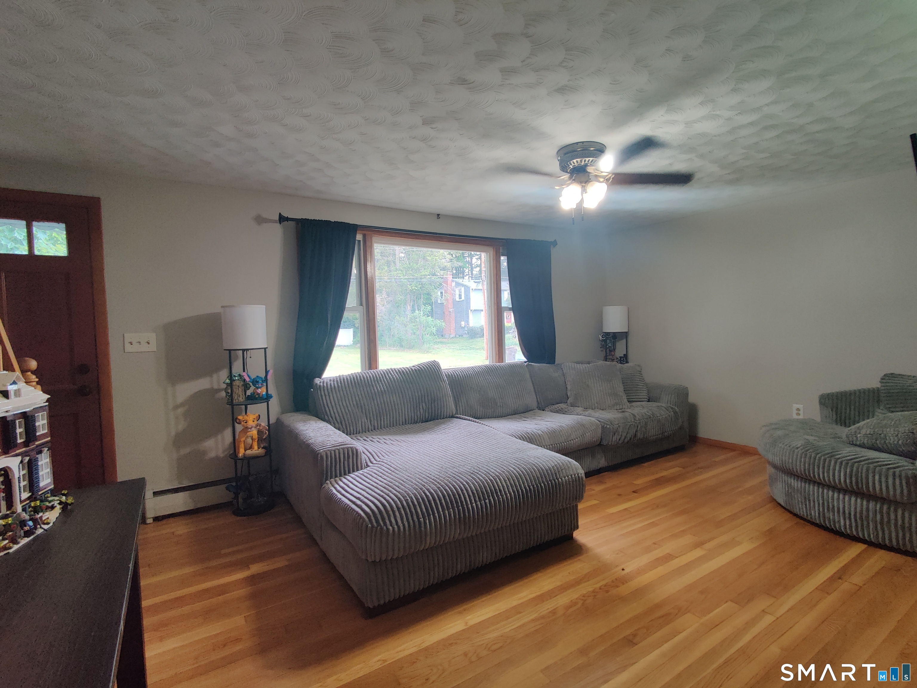 35 Brook Road Enfield, CT 06082 - Photo 8 of 25 a living room with furniture and a flat screen tv