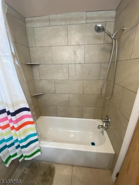 159 Prospect Street, Unit 2 Garfield, NJ 07026 - Photo 11 of 13 a bathroom with a bath tub