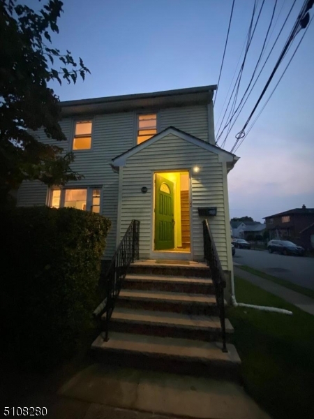 159 Prospect Street, Unit 2 Garfield, NJ 07026 - Photo 2 of 13 a front view of a house with a garden
