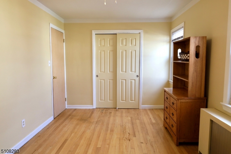 159 Prospect Street, Unit 2 Garfield, NJ 07026 - Photo 5 of 13 a view of empty room with wooden floor and fan