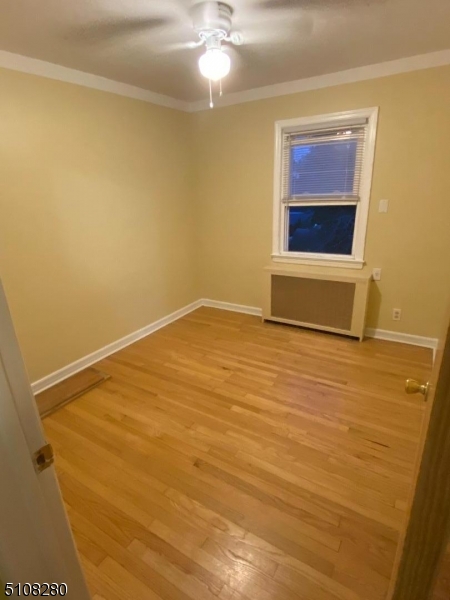159 Prospect Street, Unit 2 Garfield, NJ 07026 - Photo 8 of 13 a view of an empty room with a fireplace