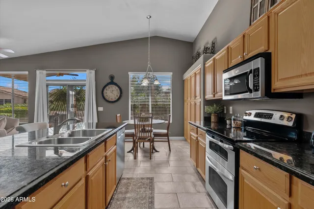 a kitchen with stainless steel appliances a sink a stove and cabinets