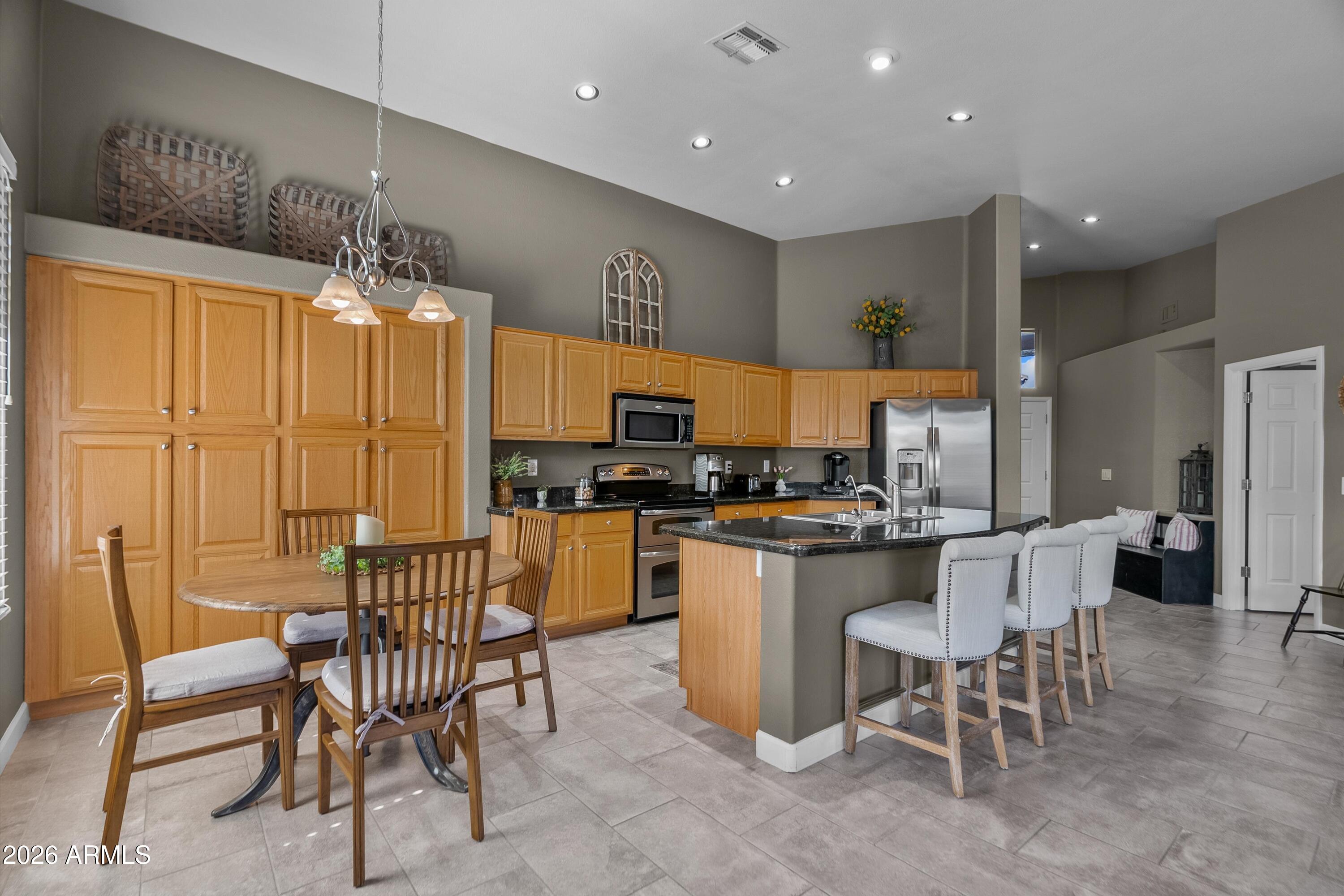 4685 East Walnut Road Gilbert, AZ 85298 - Photo 15 of 58 a kitchen with a sink and chairs