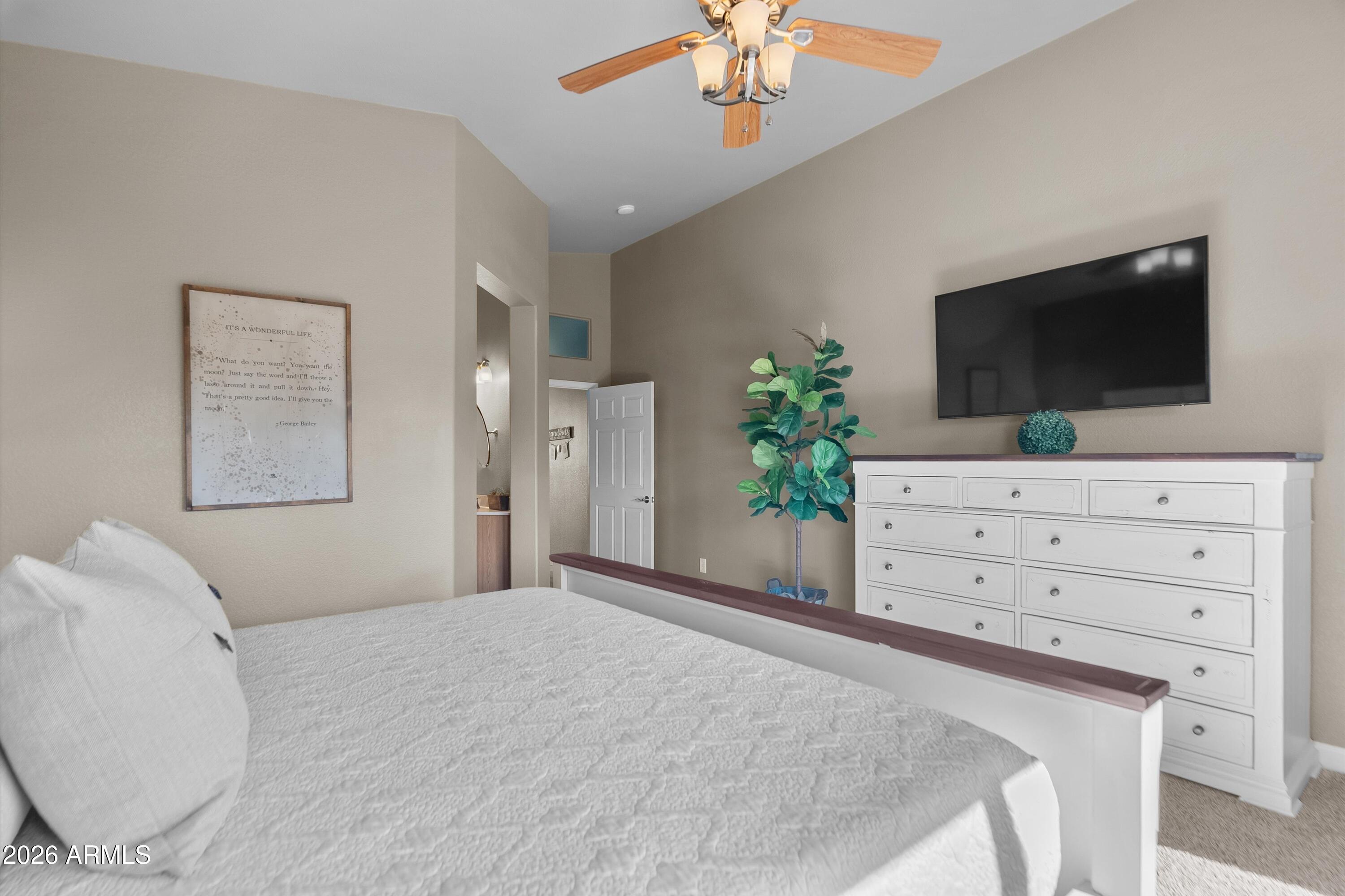 4685 East Walnut Road Gilbert, AZ 85298 - Photo 20 of 58 a bedroom with a bed and a flat screen tv