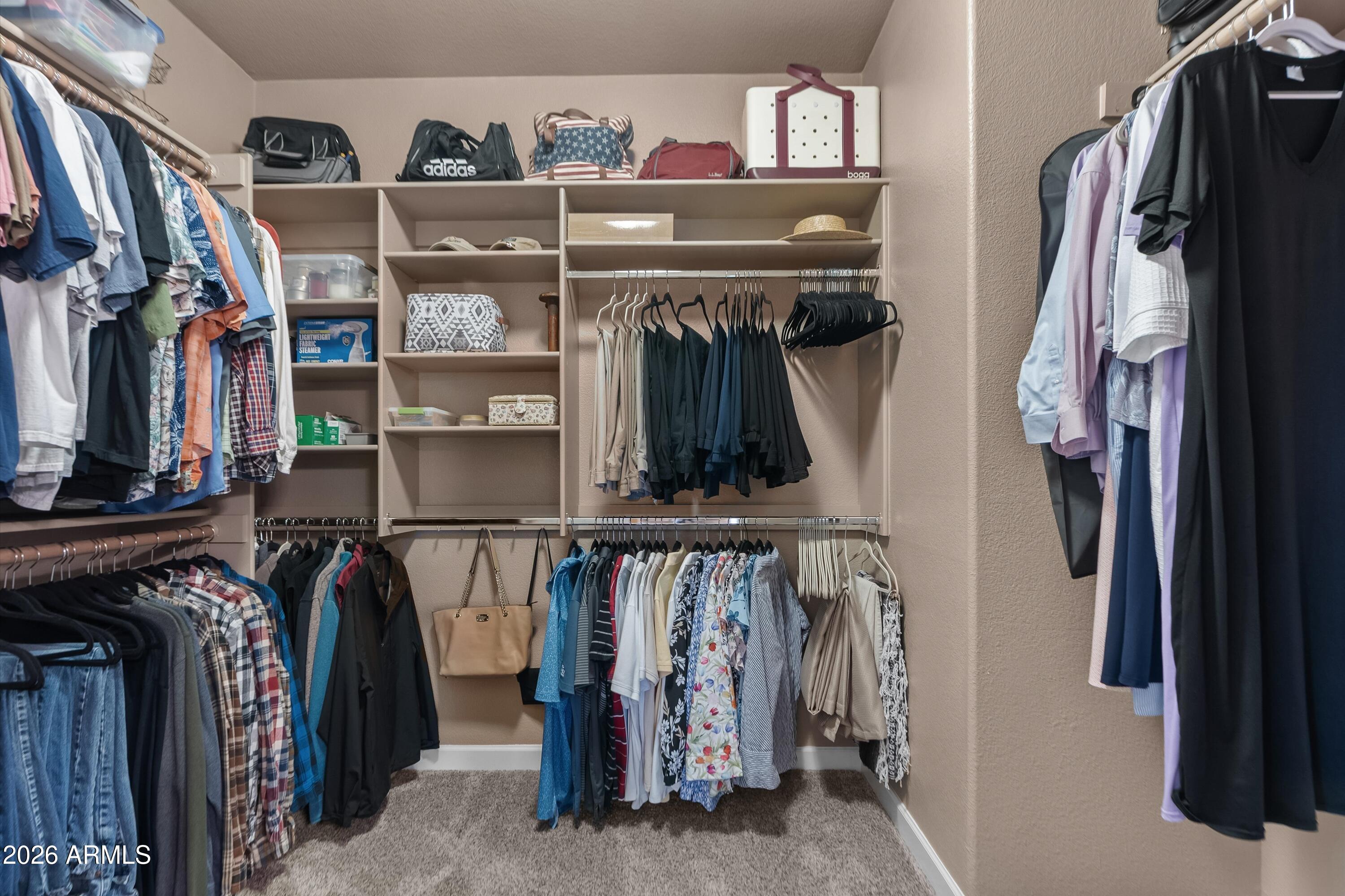 4685 East Walnut Road Gilbert, AZ 85298 - Photo 24 of 58 a view of walk in closet with clothes and shoes