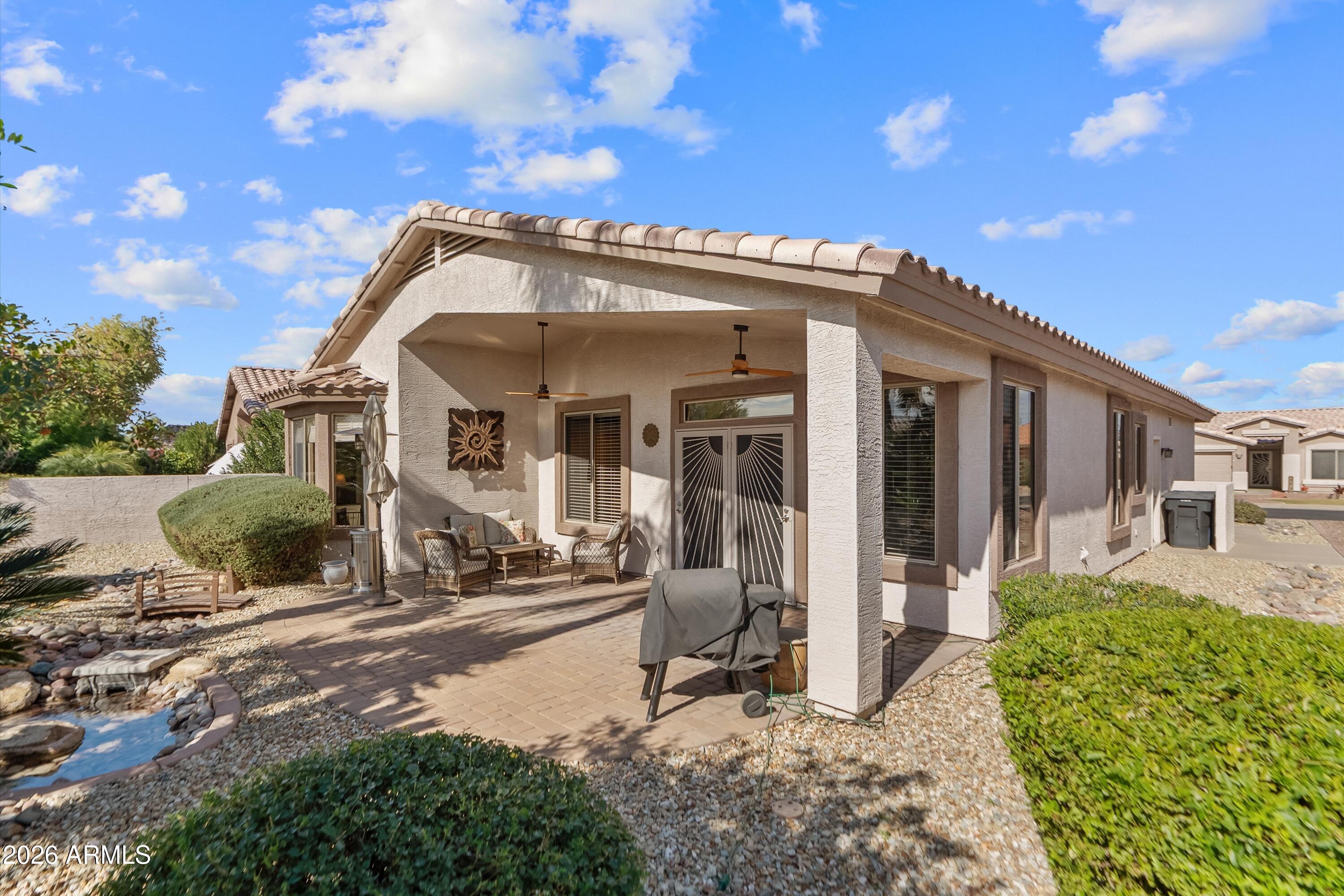 4685 East Walnut Road Gilbert, AZ 85298 - Photo 30 of 58 a view of a house with many windows and a tree