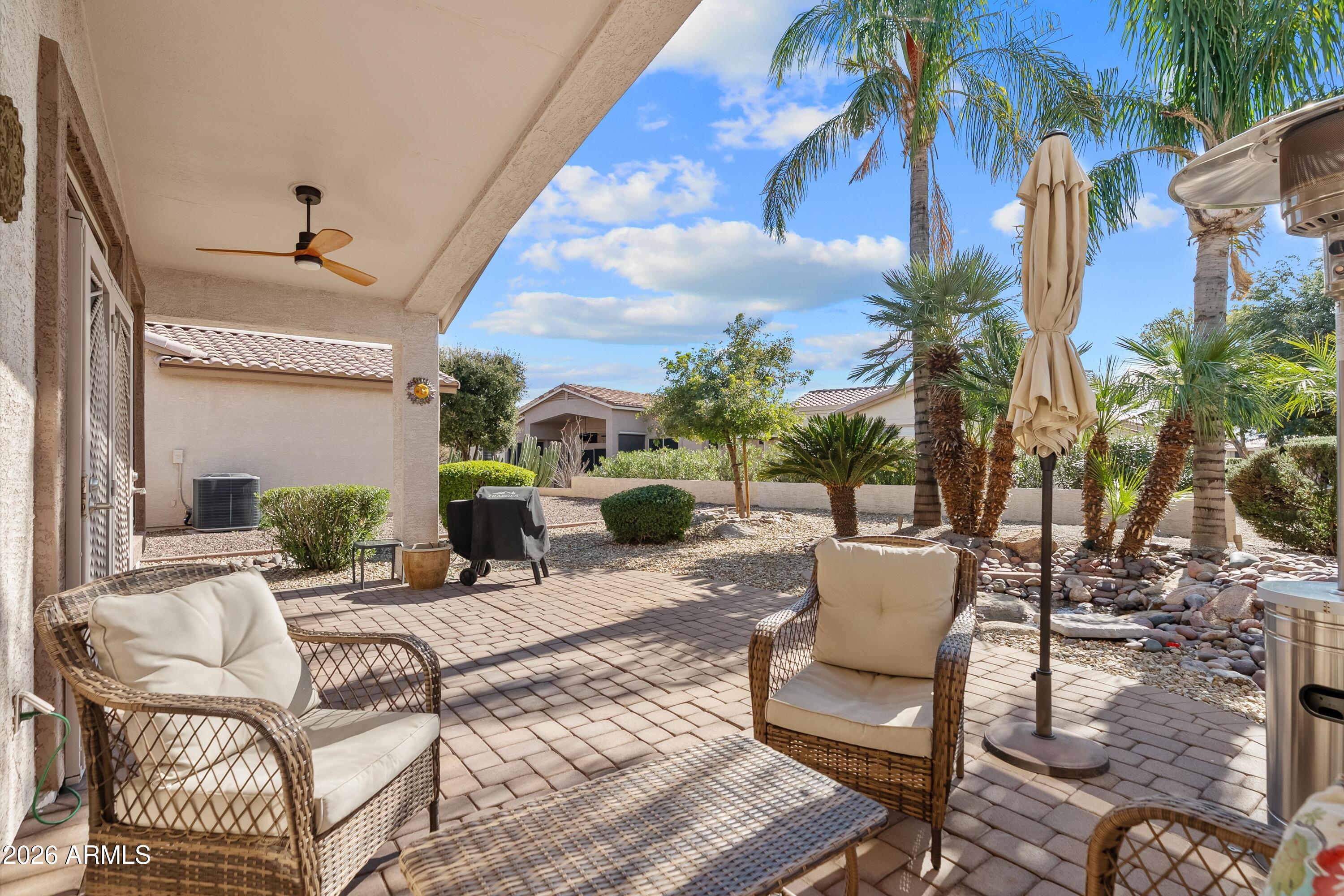 4685 East Walnut Road Gilbert, AZ 85298 - Photo 33 of 58 a view of a patio with a dining table and chairs under an umbrella